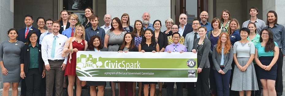 A group of CivicSpark fellows holding a banner for CivicSpark.
